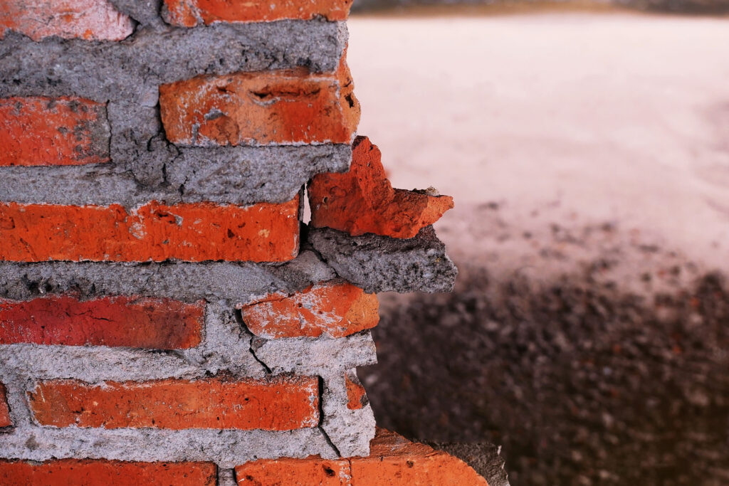 Close up image of broken and damaged bricks on a chimney.
